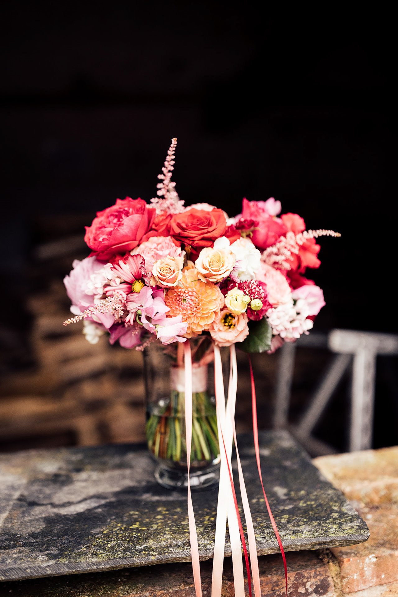 pink and red bouquet with ribbons for a fun party wedding in the cotswolds