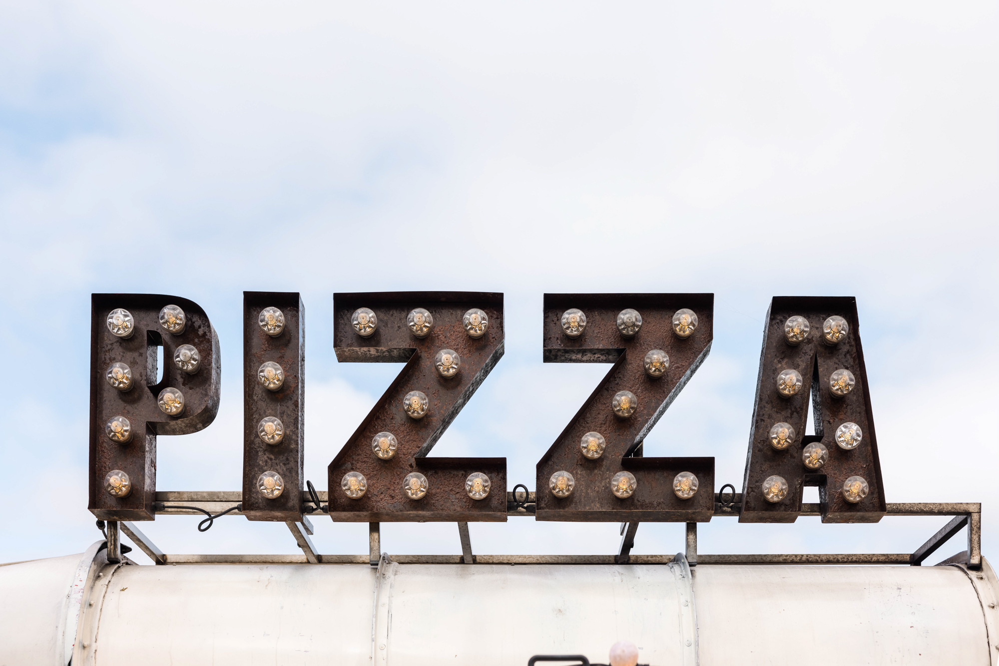 Wedding pizza from a cool truck with light up sign at wedding fair in the cotswolds