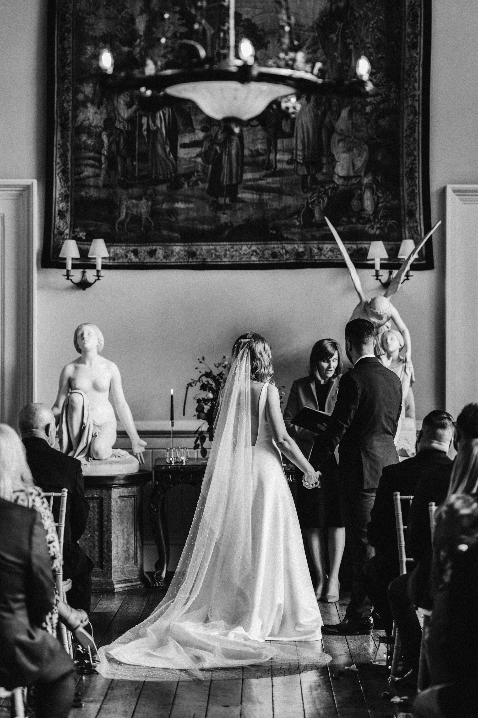 Moody photo of historic stately home wedding ceremony with dark vibes in october
