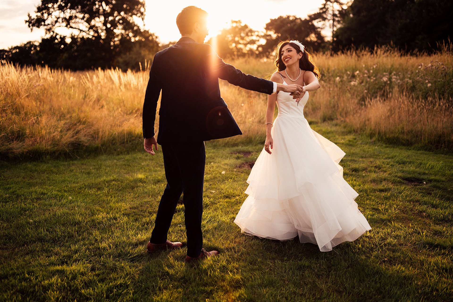 Engagement story: how he proposed. Photo of bride and groom dancing at sunset outdoors at wild wedding venue elmore court