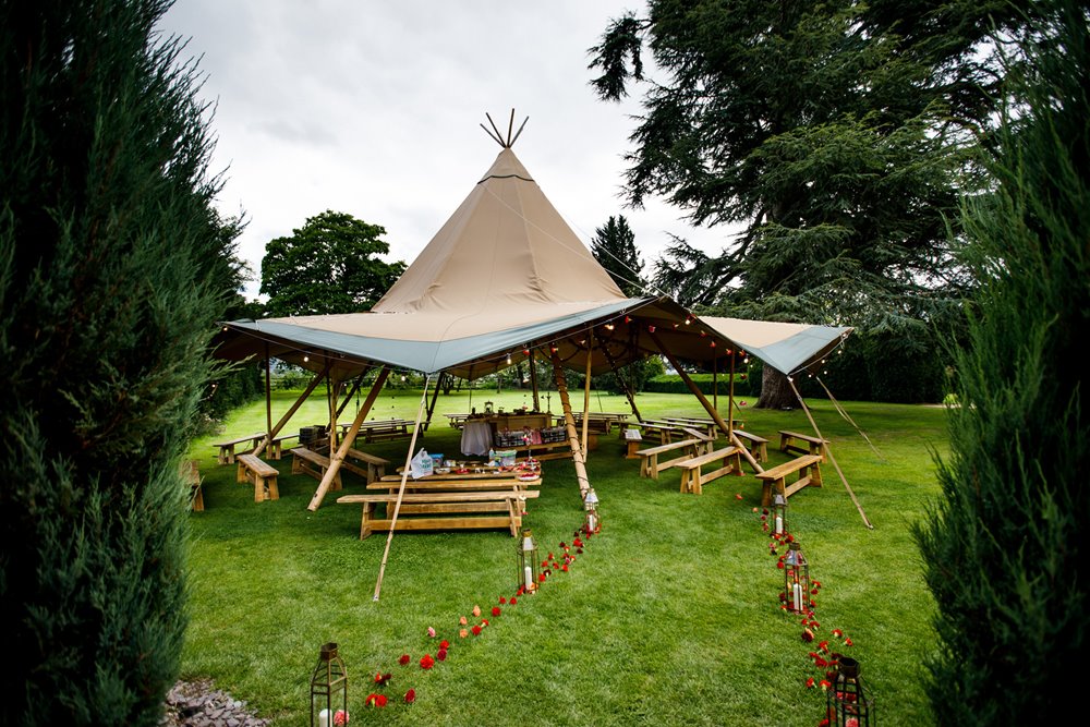 Kata tent with petal aisle in the grounds for a Hindu blessing and fusion gay wedding ceremony