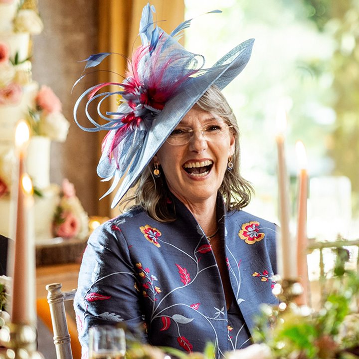 mother of the bride in beautiful outfit of silk pattern jacket and matching hat by shibumi uk