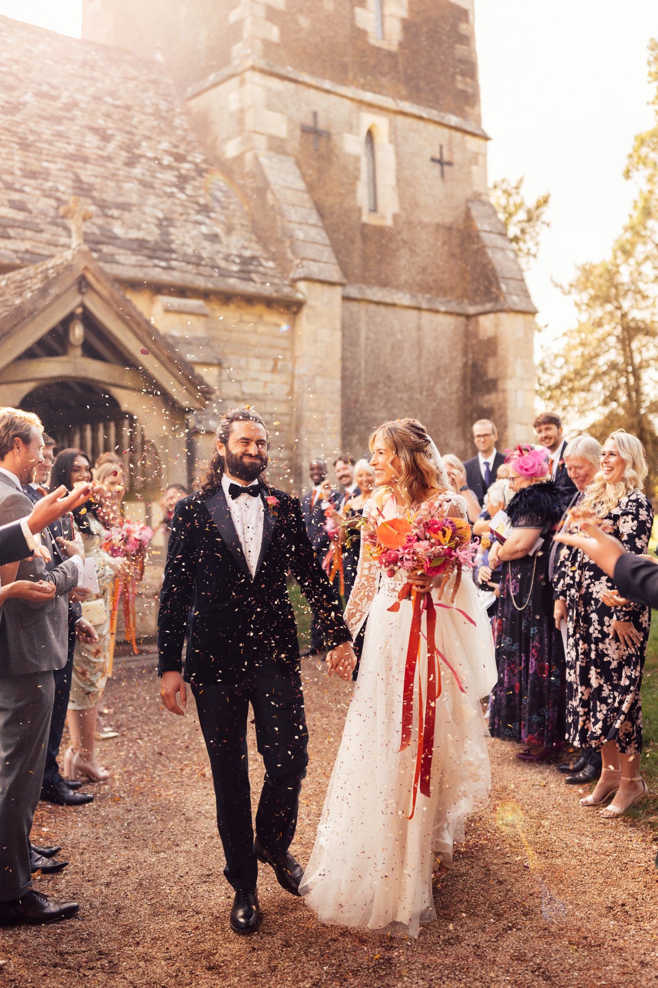 bride and groom confetti outside church