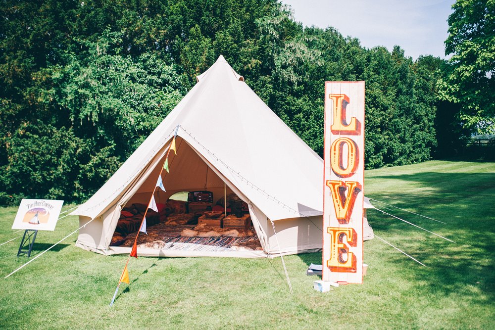 Festival wedding inspiration bell tent and love sign outdoors at elmore court 2021 and 22 weddings