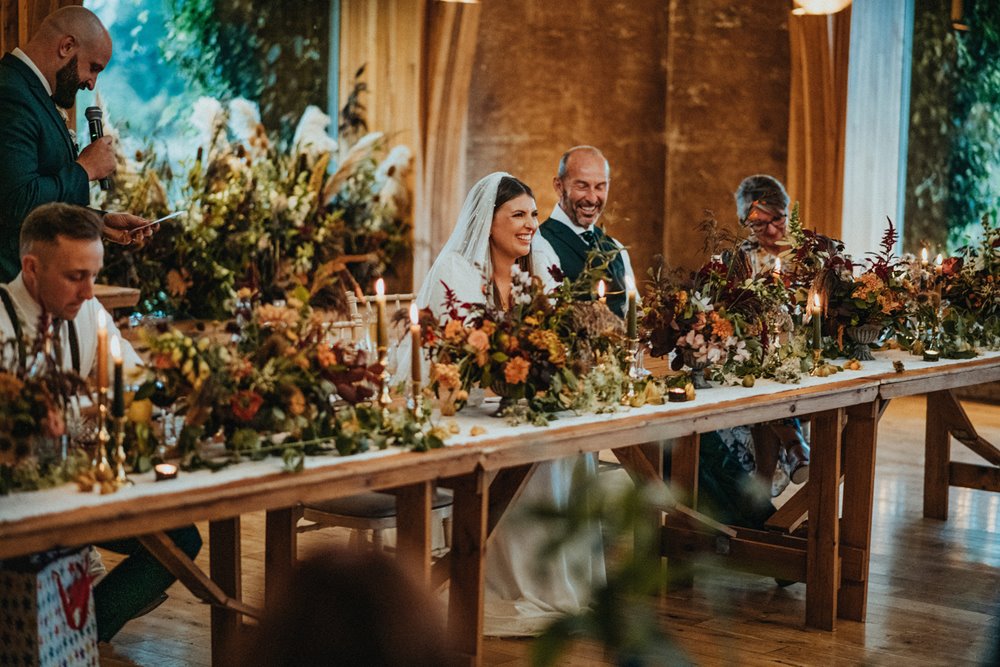 Rustic romantic wedding reception flowers and decor at cotswolds eco wedding venue