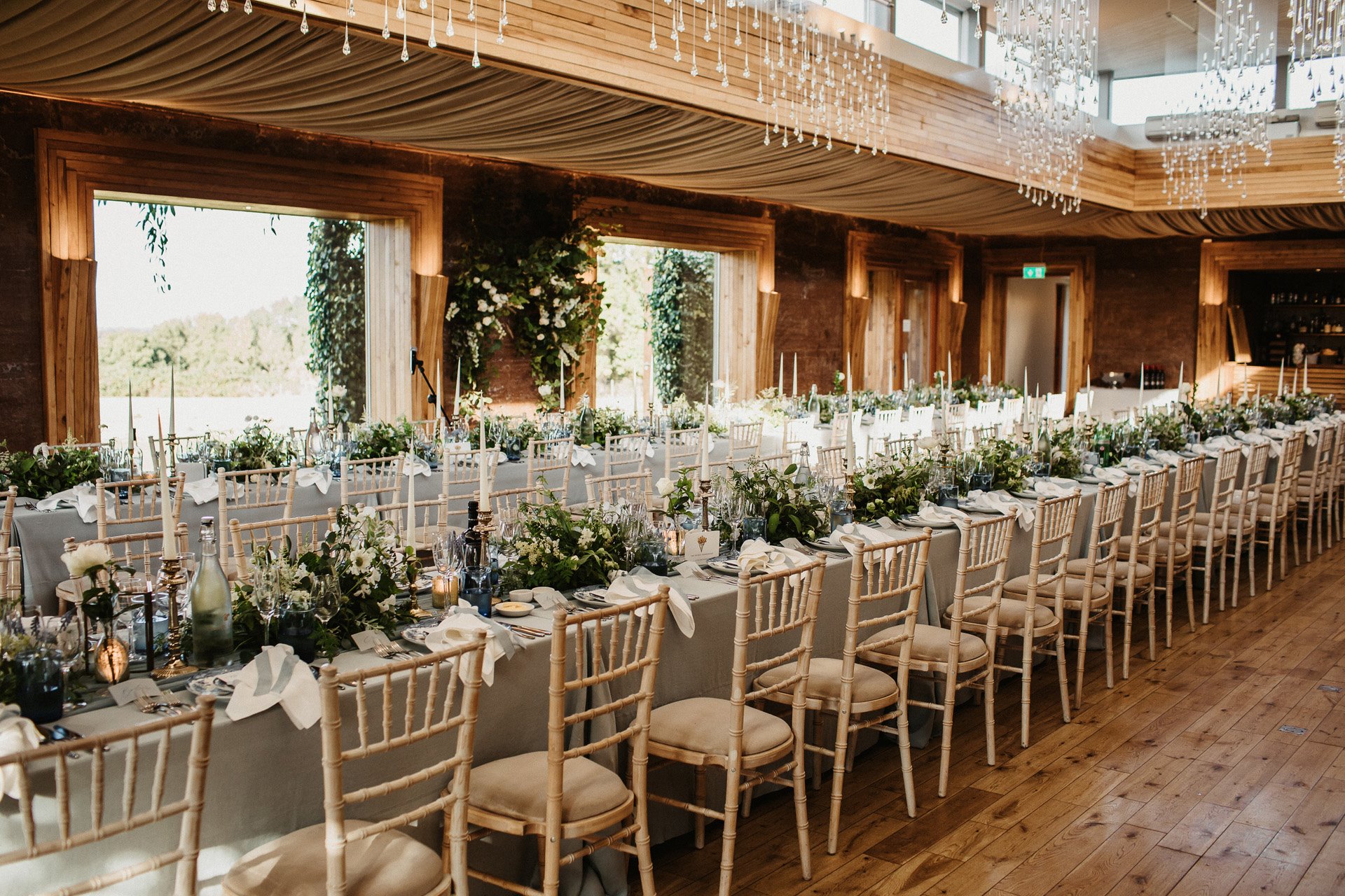 long banqueting table arrangement with linen and foliage for a wedding at elmore court