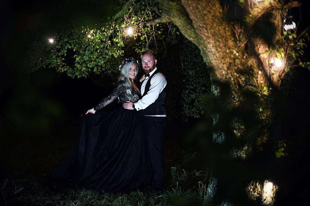 Magical photoshoot of Halloween wedding with bride in black lace wedding dress