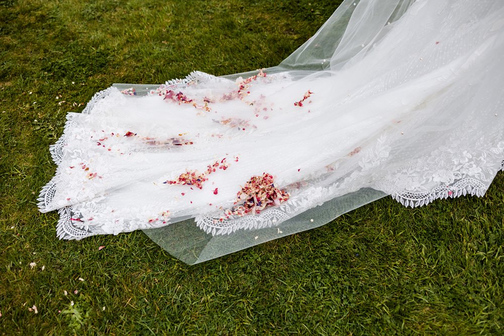 brides wedding dress with confetti on her wedding dress train