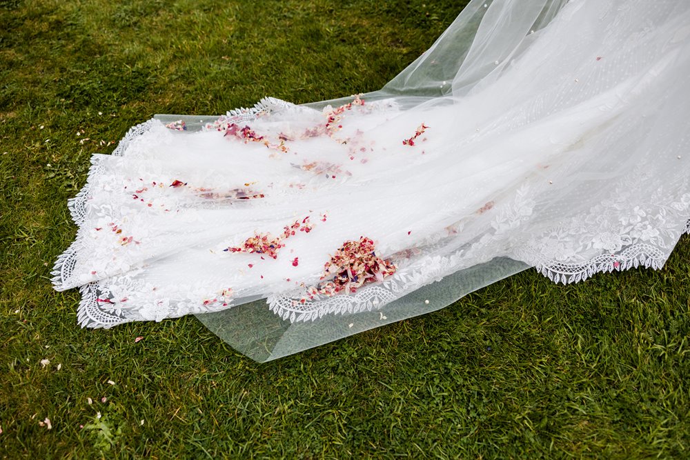 brides wedding dress with confetti on her wedding dress train