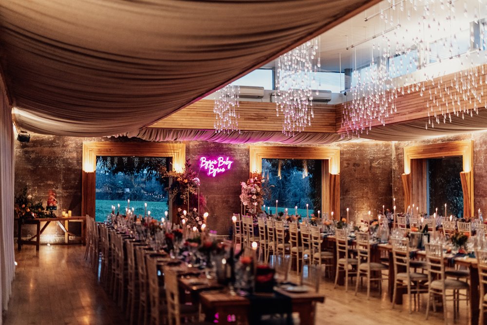 winter wedding party reception with neon signs and bright decor