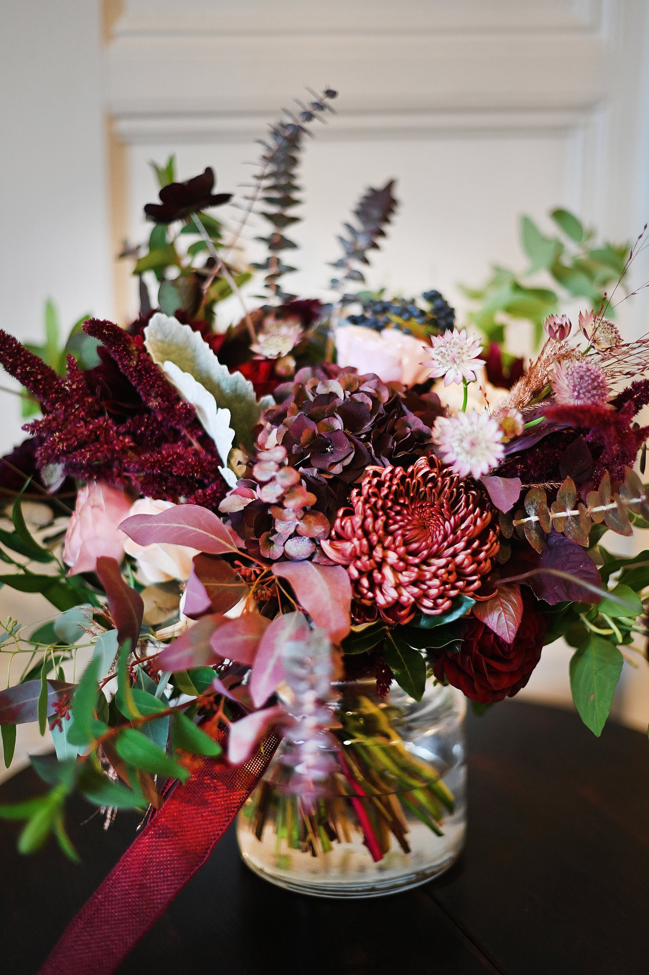 autumn wedding flowers in deep berry tones for a halloween wedding at stately home elmore court