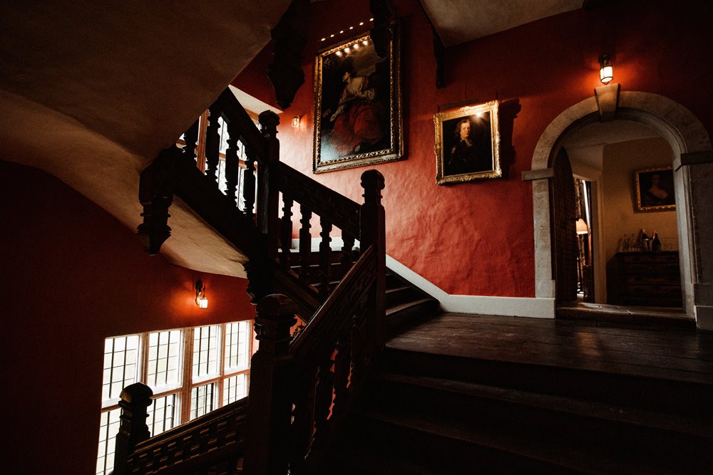 Ancient stately home with beautiful old red stairway can now be yours to party all night in if you're getting married in the Cotswolds
