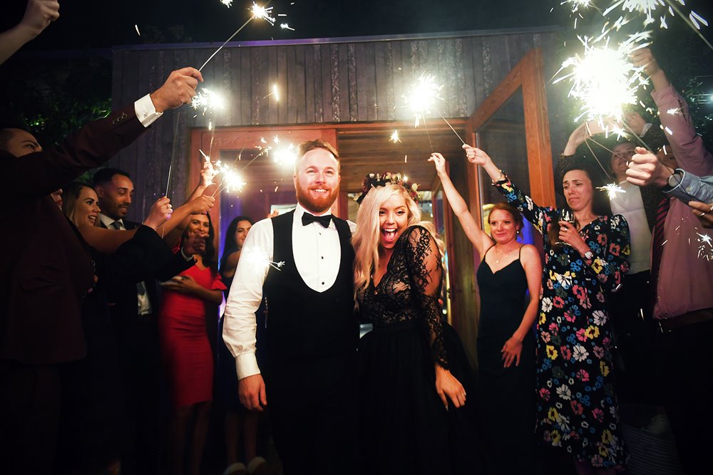Magical sparkler exit for a halloween loving bride in black wedding dress