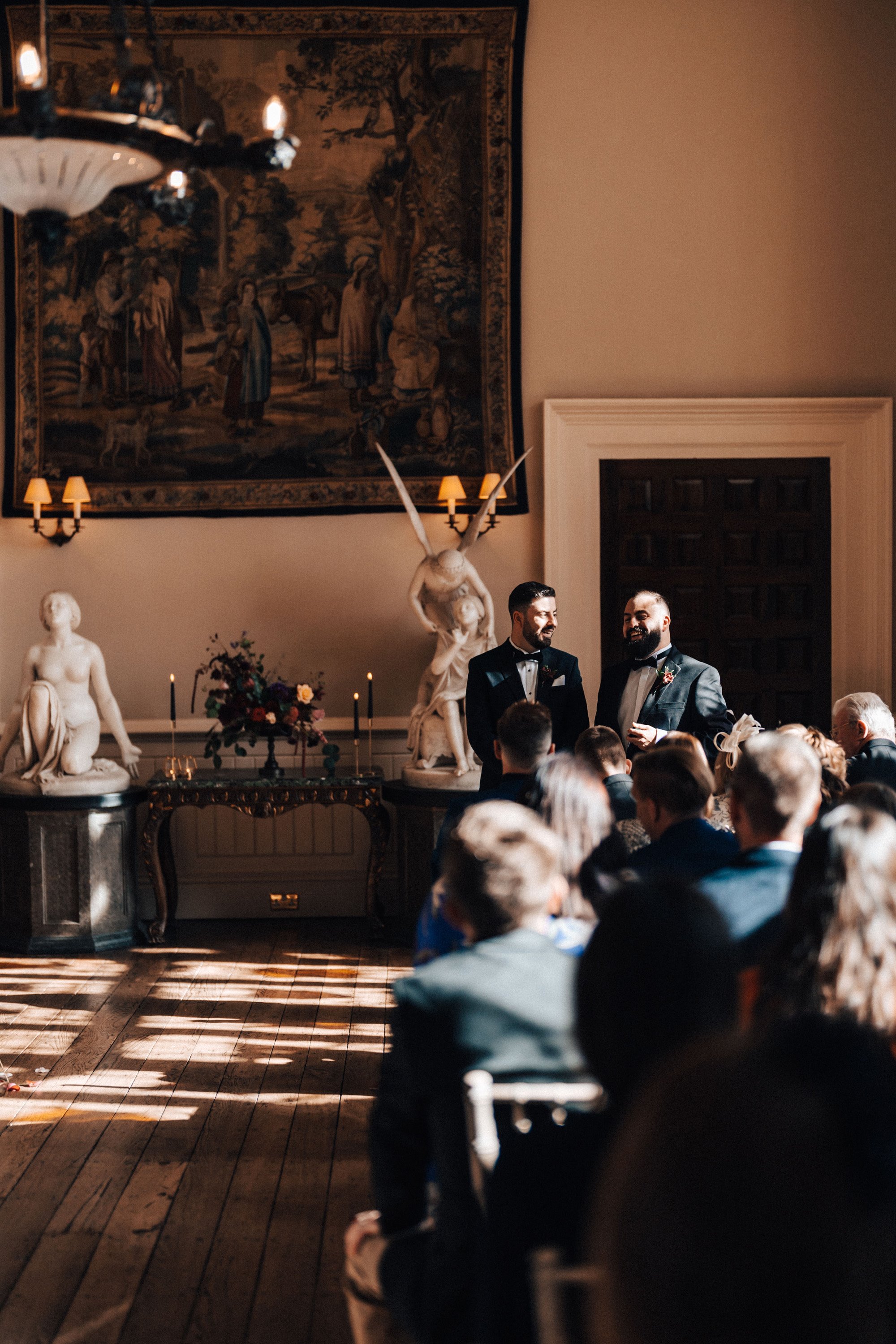 groom waits for bride at autumn wedding ceremony in a historic english country manor house