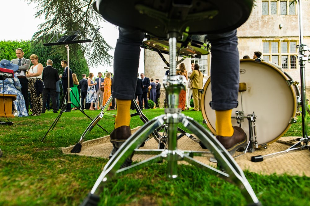 Wedding musicians playing outside under the cedar tree at elmore court