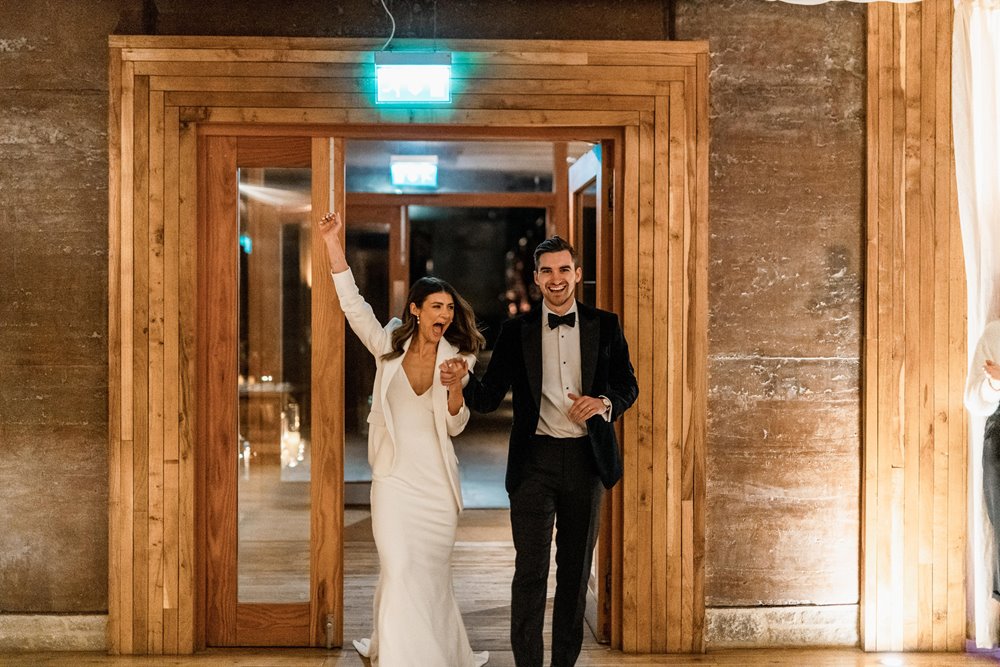 Bride and groom entrance as newlyweds