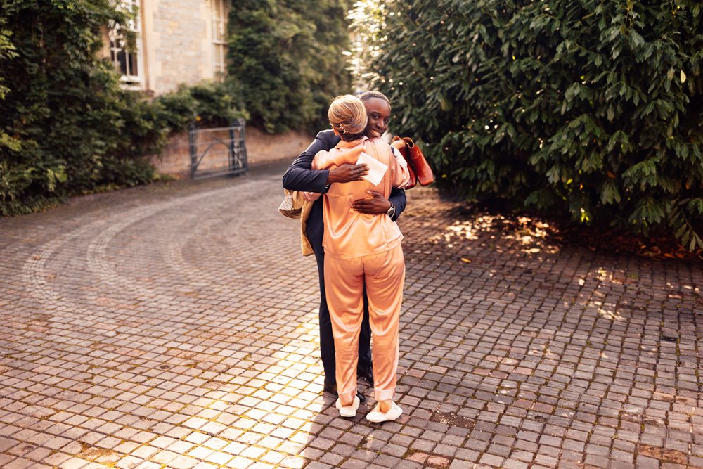 wedding morning bridesmaid and bridesman hug