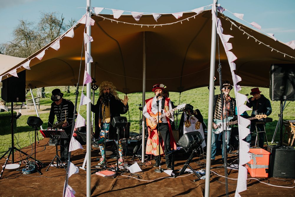 Curious little big band glastonbury festival band playing under stretch tent in Gillyflower meadow for a wedding fair at elmore court