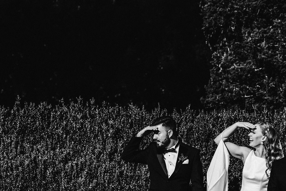 cool bride and groom pose in autumn sun at their stately home wedding in october