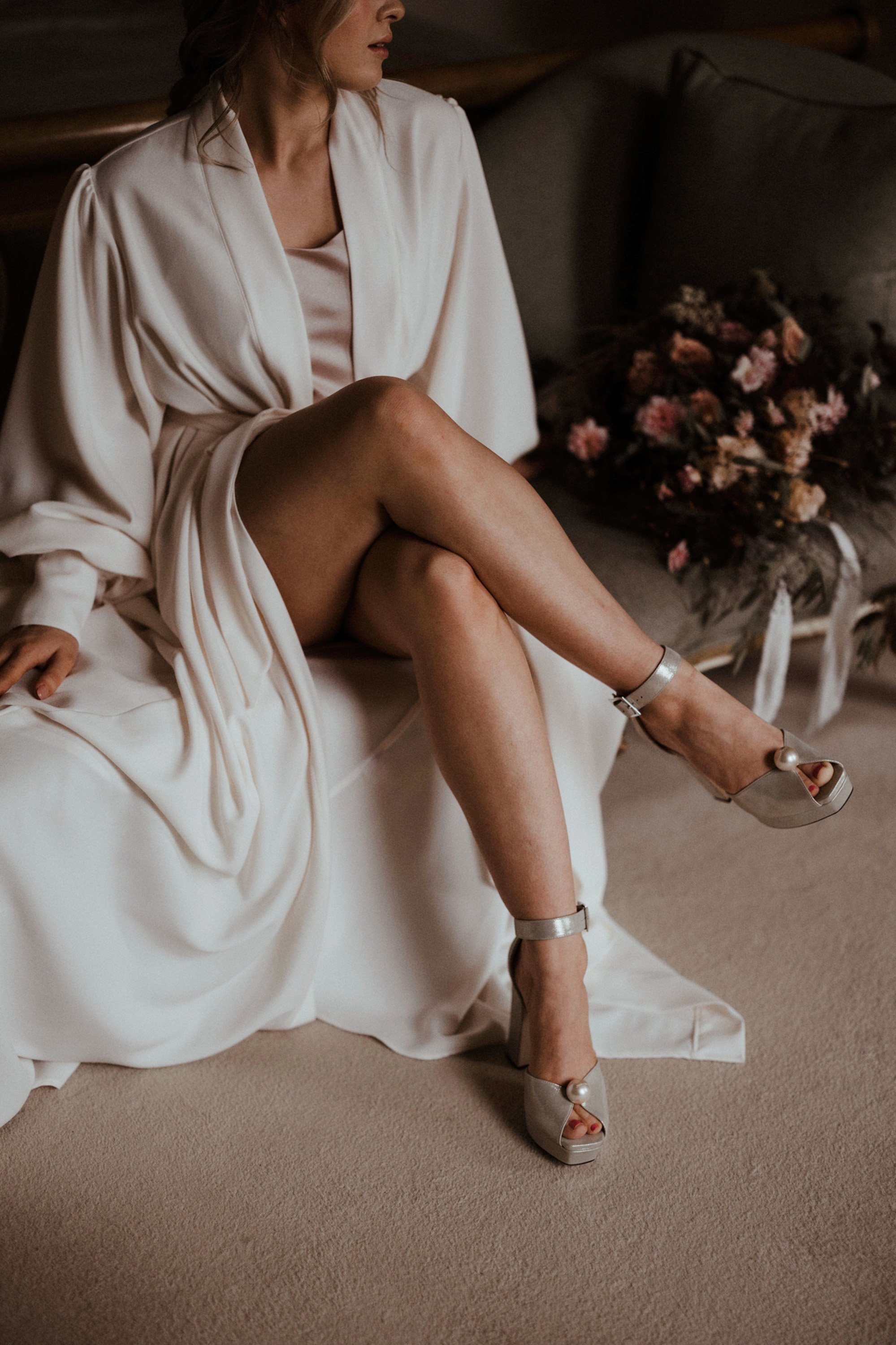 Boho bride in long flowing robe and sexy jimmy choo chunky wedges with pearl
