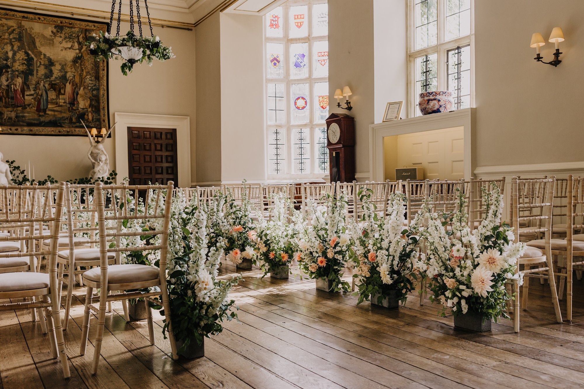 lovely sun lit wedding ceremony in the great hall of a stately home in gloucestershire