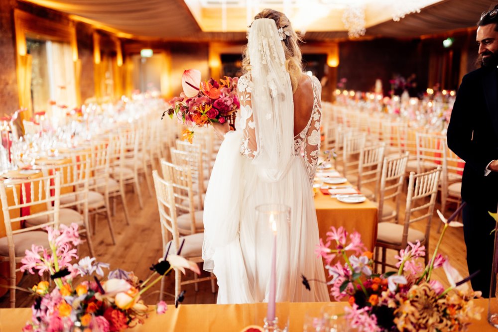 boho bride and groom see their colourful wedding reception for the first time