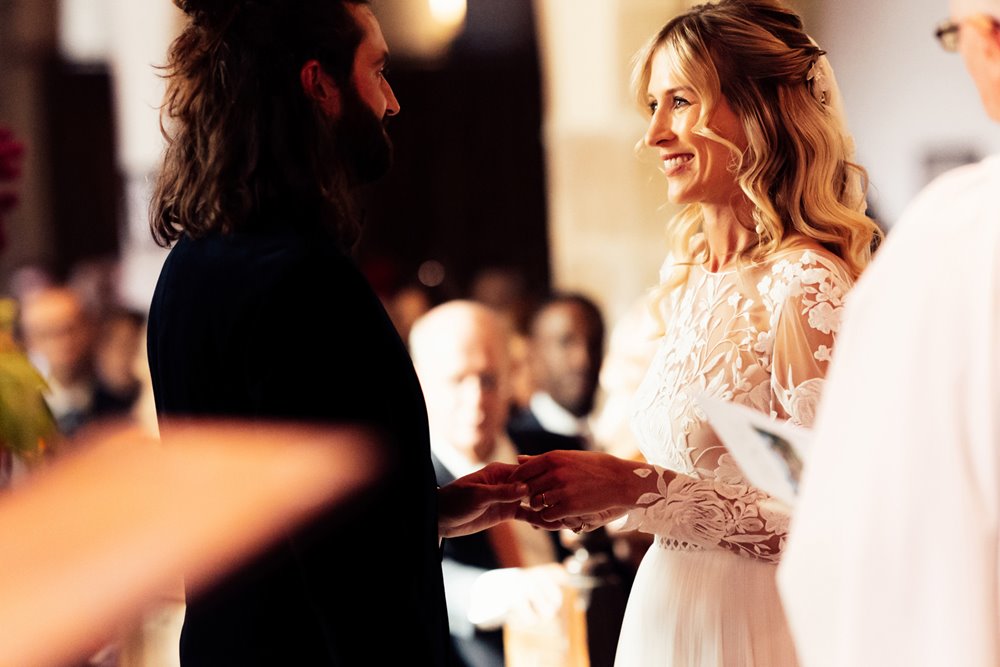 bride and groom exchanging rings at church ceremony in elmore