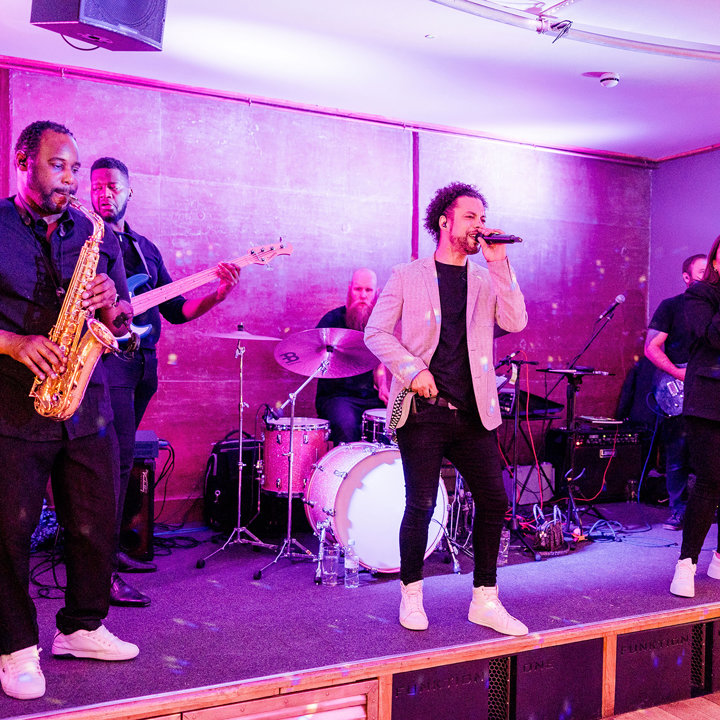 Wedding band with sax on stage at The Gillyflower a wild wedding venue with soundproof party venue at Elmore Court in the Cotswolds