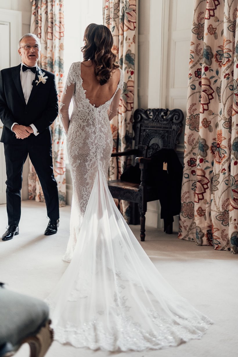 Glamorous bride in lace backed dress getting ready to be married