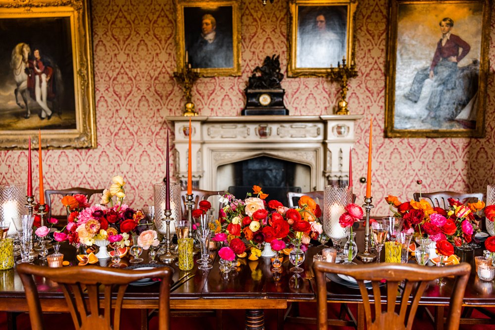 Bright bold riot of colour wedding inspiration with red, pink and orange spring flowers for a festival wedding fair in gloucestershire elmore court