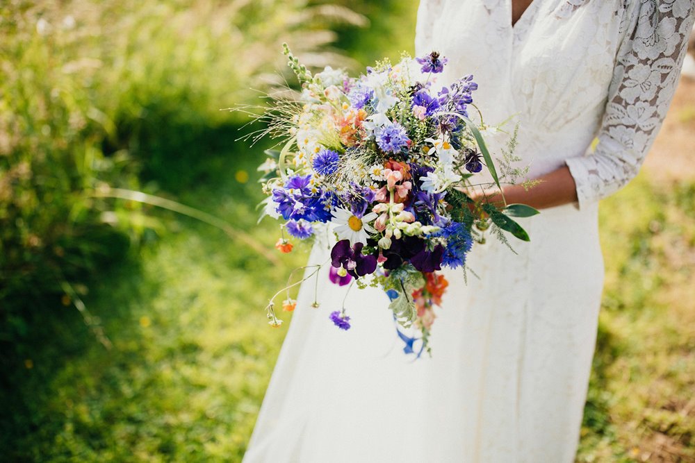Asian bride holds wildflower wedding bouquet