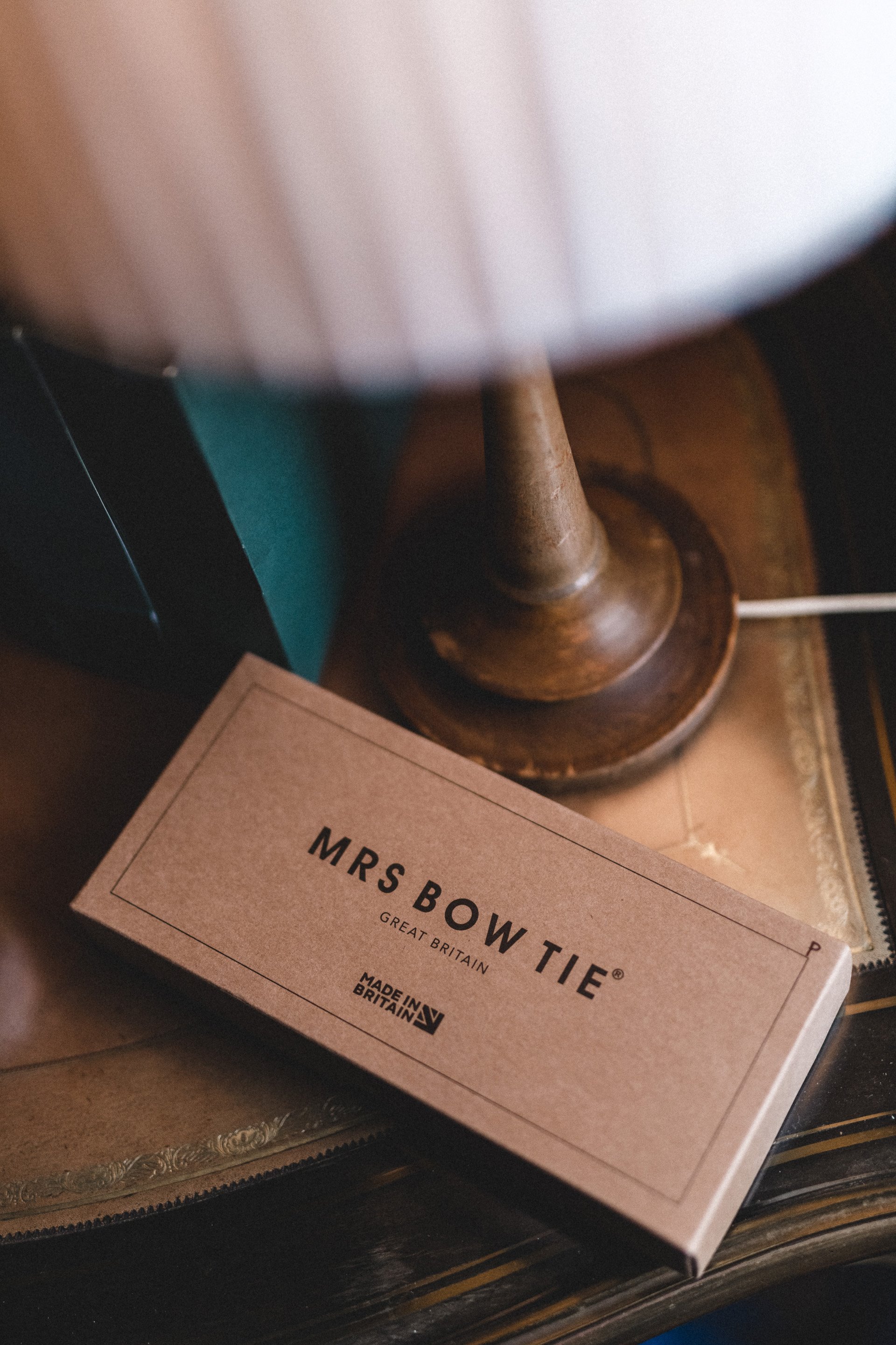 Bowtie box on the side table at a gay wedding in the cotswolds