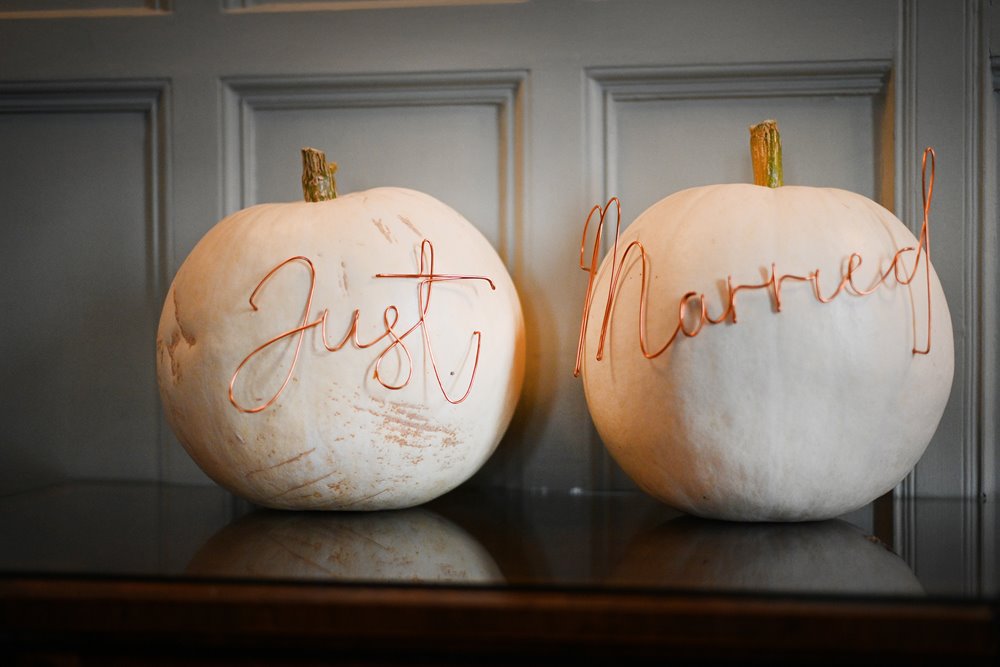 hundreds of White pumpkins were home grown by the bride for this halloween wedding and decorated with wedding signs in copper wire