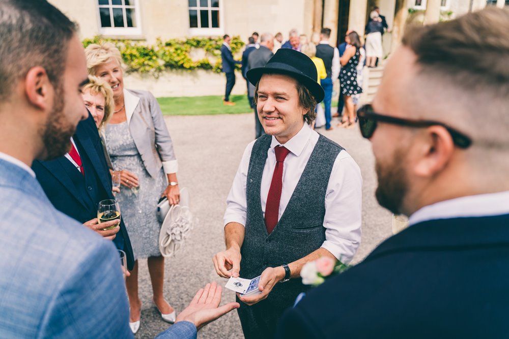 Magician entertaining guests at an outdoor wedding 2021