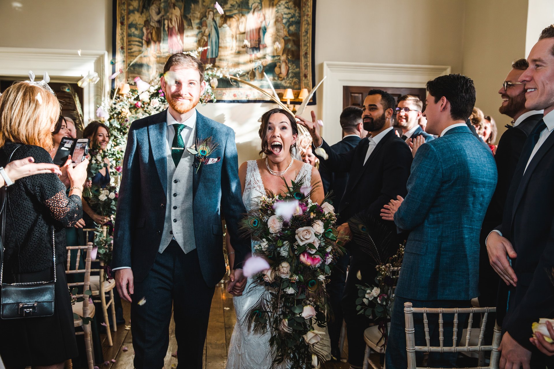 Just married bride and groom confetti shot in beautiful hall at elmore court