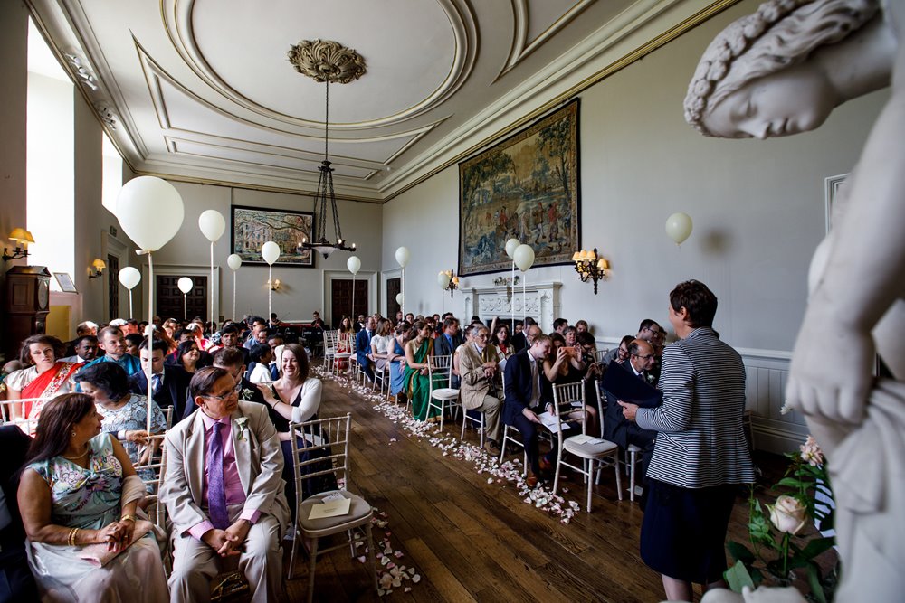 Same sex wedding ceremony hall at mansion Elmore Court decorated with white balloons