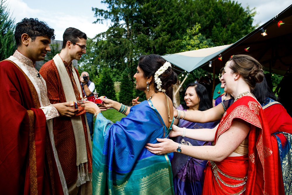 A welcoming into the family at a beautiful gay fusion wedding outdoors at Elmore Court