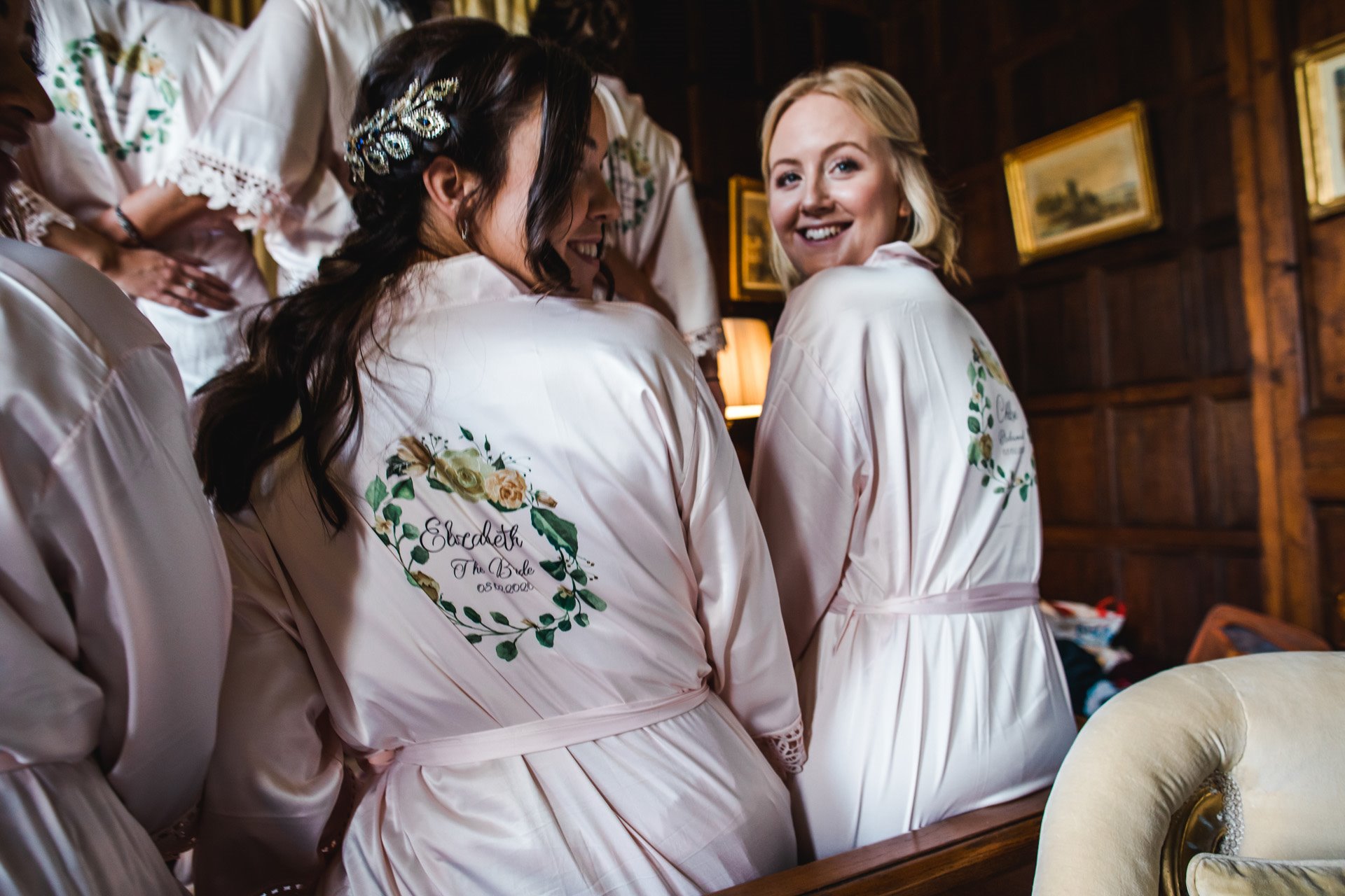 Bridesmaids in personalised dressing gowns smile together