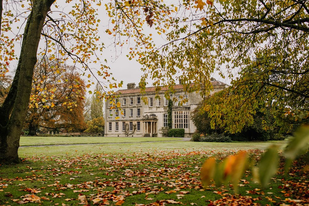 Autumn leaves surrounding stately home elmore court in the cotswolds