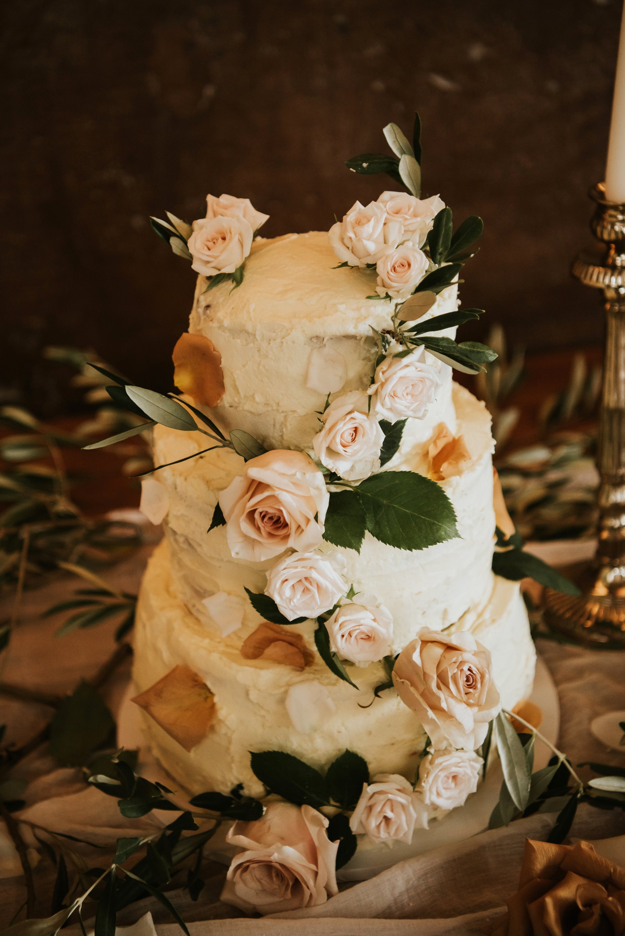 white roses around an elegant wedding cake