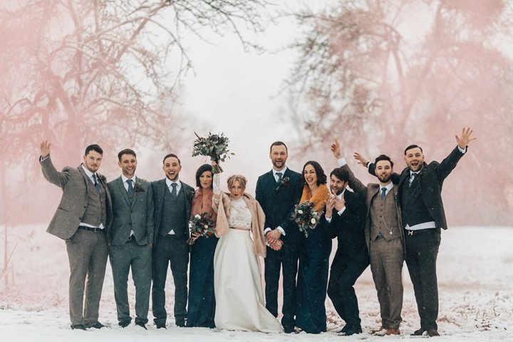 Winter wedding in the snow with smoke bombs