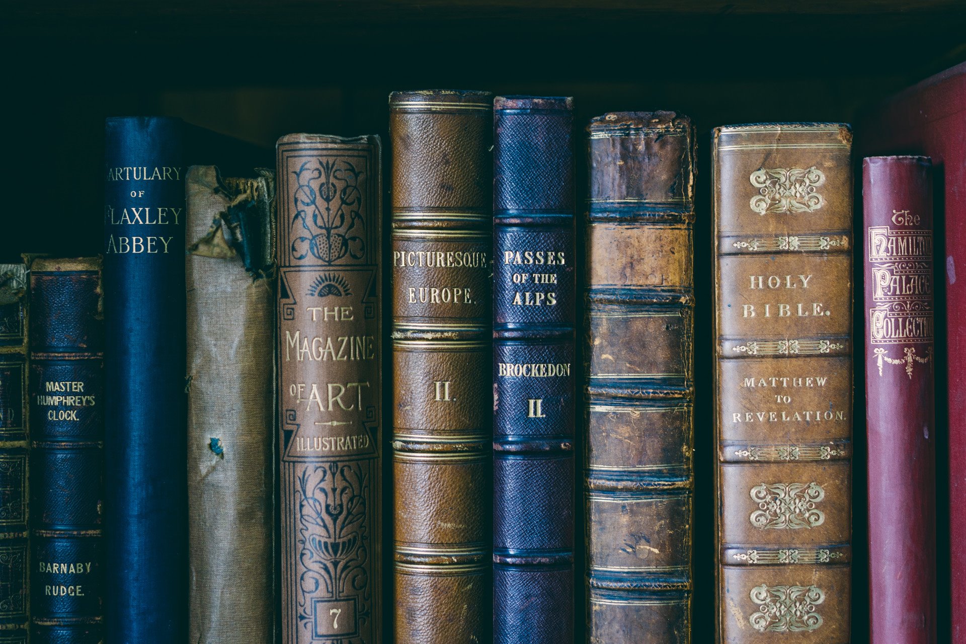 old books on one of the many bookshelves in the bedrooms of 16th century stately home elmore court