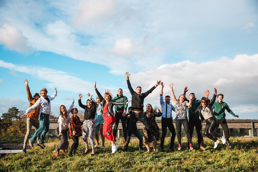 Team E! Wedding and events team at Elmore Court jumping for joy on top of the eco reception roof