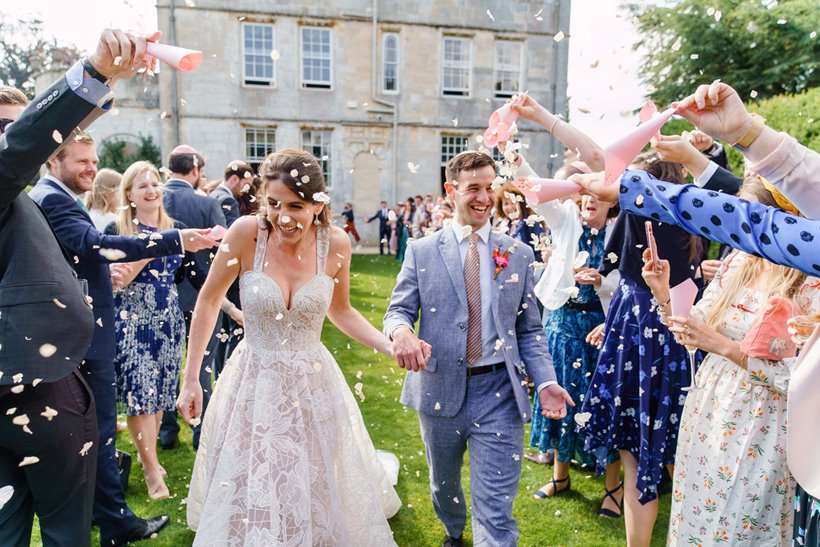 Bride and groom confetti shot on the lawn of stately home elmore court