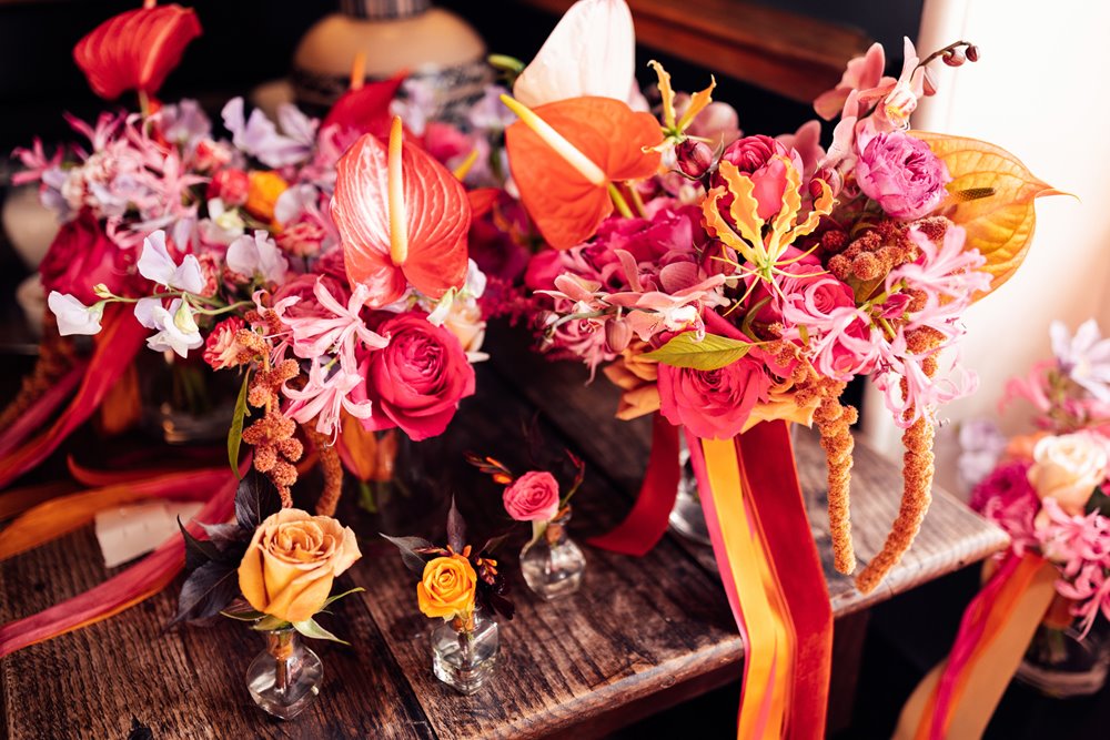 Bright colourful wedding flowers in pink red and orange theme for a fun wedding at elmore court